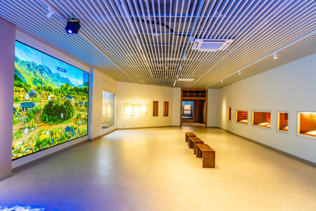 Japanese colonial interrogation documents displayed at the Hwaseong Independence Movement Memorial, low-light museum interior ISO 2000