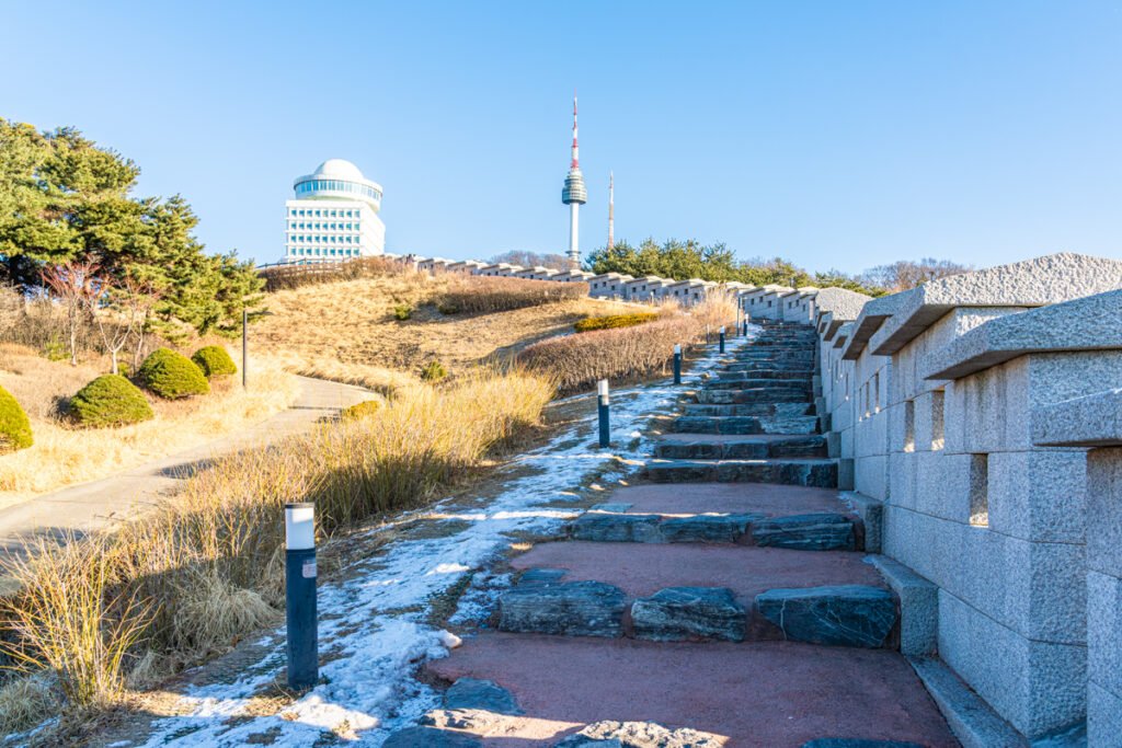 N Seoul Tower winter hiking trail through bare Namsan forest with stone steps