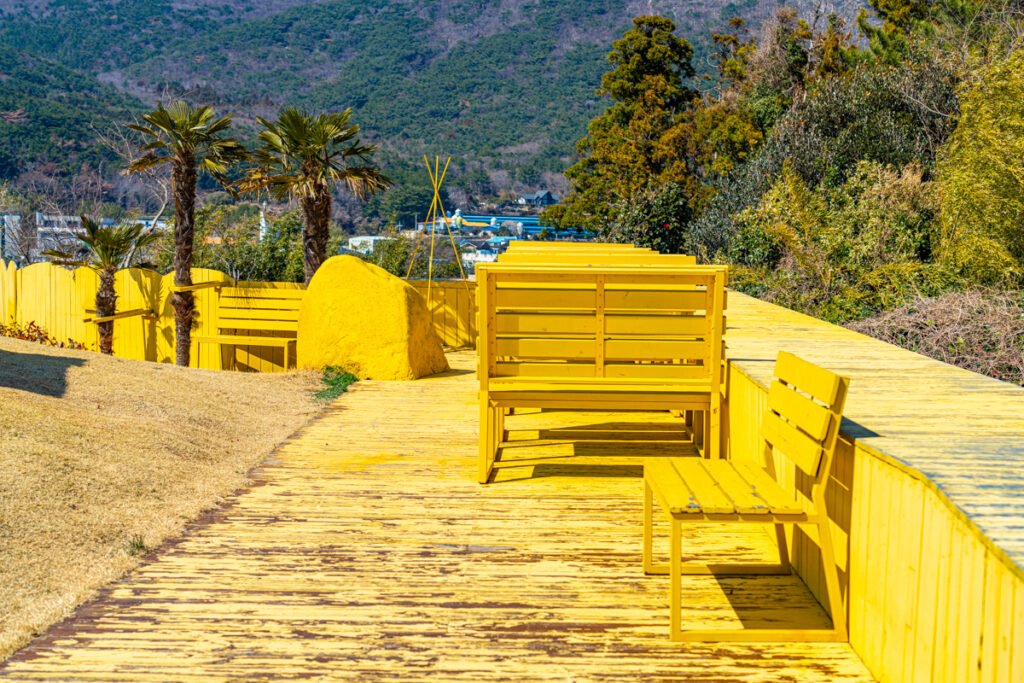 Norang Budeong yellow garden with palm trees and sea view Geoje spring travel Sony a7R4